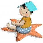 small child sitting on starfish, with a book on their head